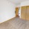 spacious, carpeted bedroom with access to laundry closet